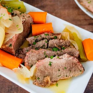 sliced corned beef brisket on a white plate