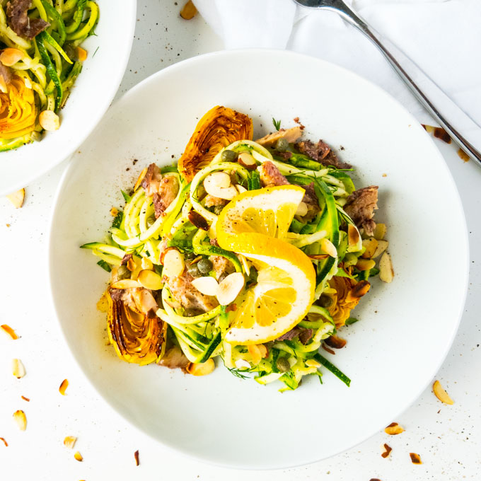 Mediterranean summer pasta with zoodles is our perfect quick, one pan low-carb version of pasta de sardina. Lemony artichokes with herbs, sardines and zucchini noodles. Peelwithzeal.com #glutenfree #summerrecipe #sardinerecipe #onepot #zoodles #zucchininoodles #30minuterecipe #fast #easy #quick #dinner #weekendlunch #wahlsprotocol