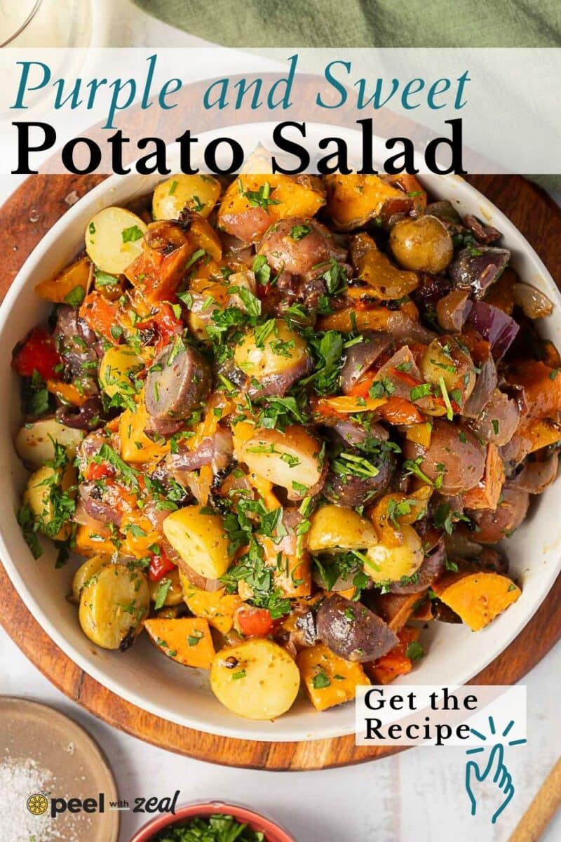 A bowl of colorful Rainbow Potato Salad featuring purple, yellow, and orange potatoes, garnished with chopped herbs. Text overlay reads: "Purple and Sweet Potato Salad. Get the Recipe.