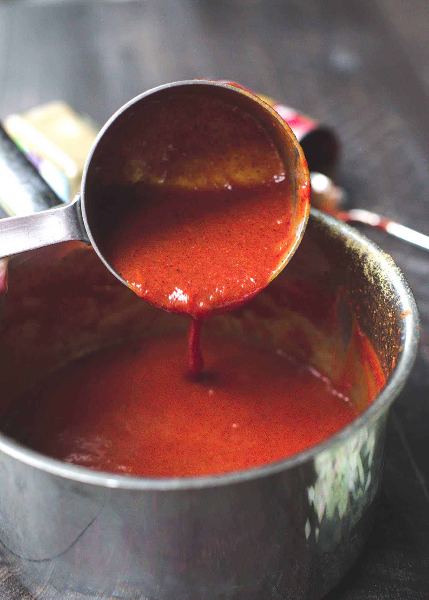spooning out red sauce