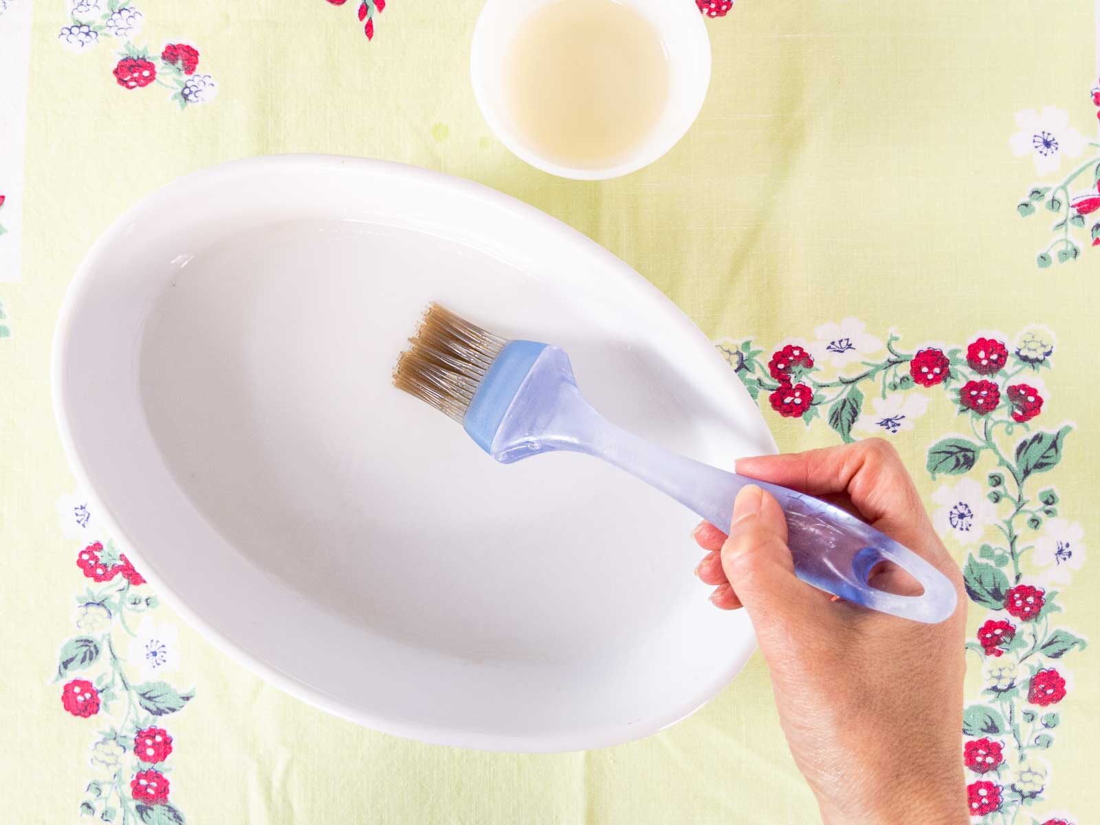 brushing oil into baking dish