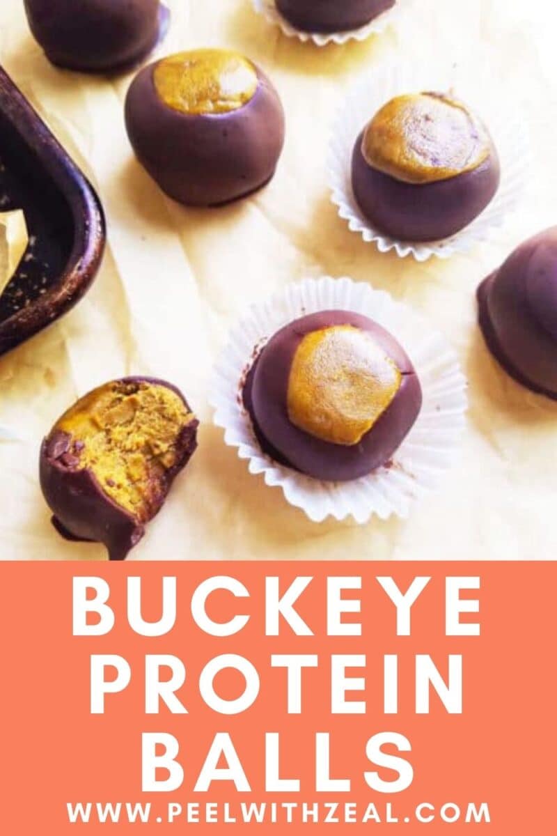 Buckeye protein balls, including a partially eaten one, are arranged on parchment paper. Text reads: "Keto Buckeyes Protein Balls www.peelwithzeal.com".