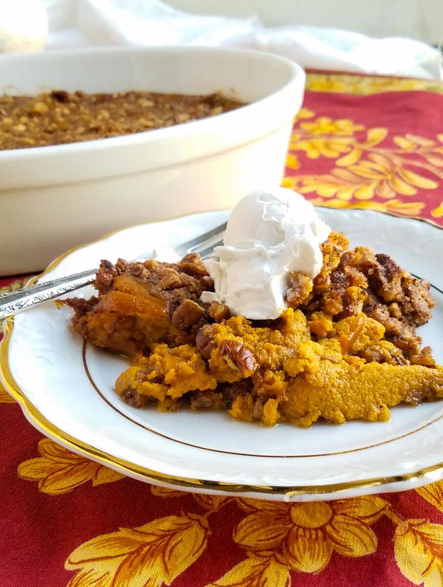 sweet potato crunch on a plate with casserole dish behind it.