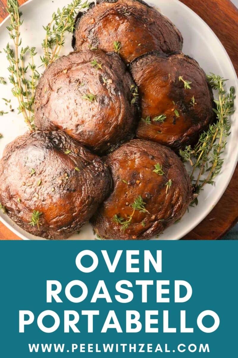 Four perfectly roasted portabella mushrooms rest on a pristine white plate, garnished elegantly with fresh thyme.