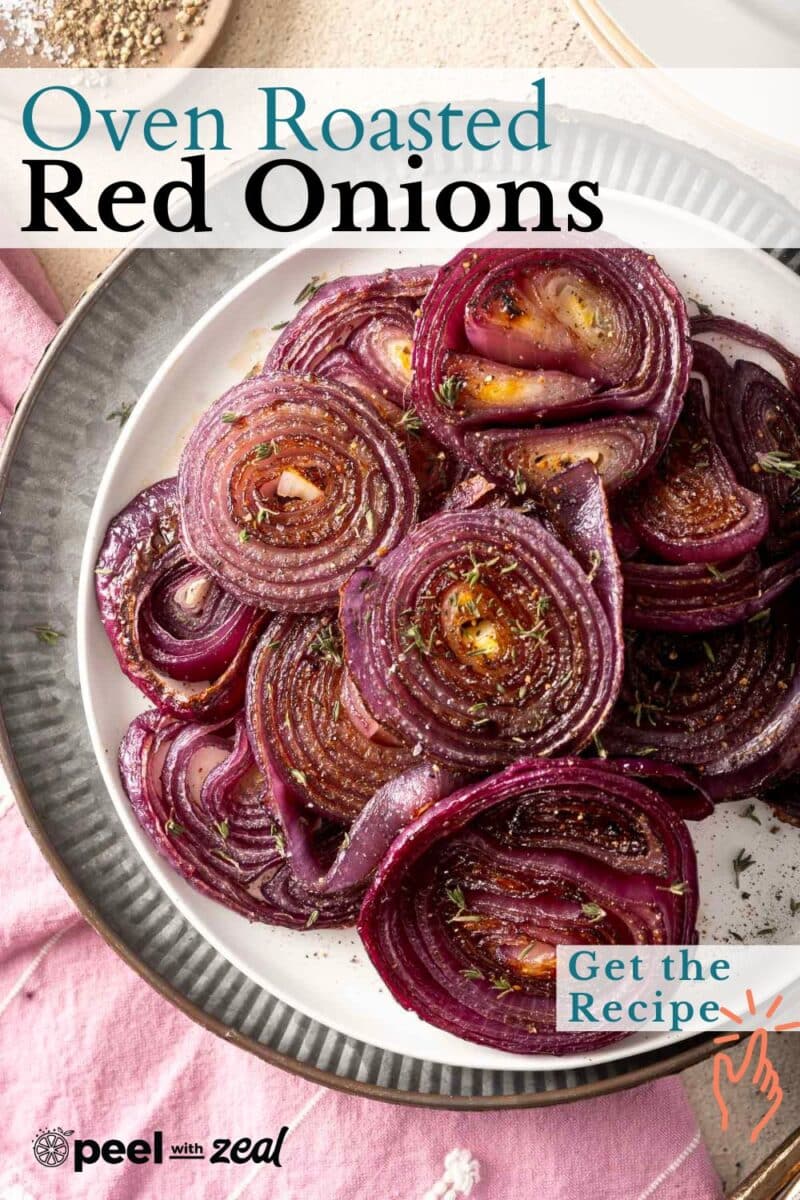 A plate of perfectly roasted red onions sprinkled with herbs sits elegantly on a gray and white dish.