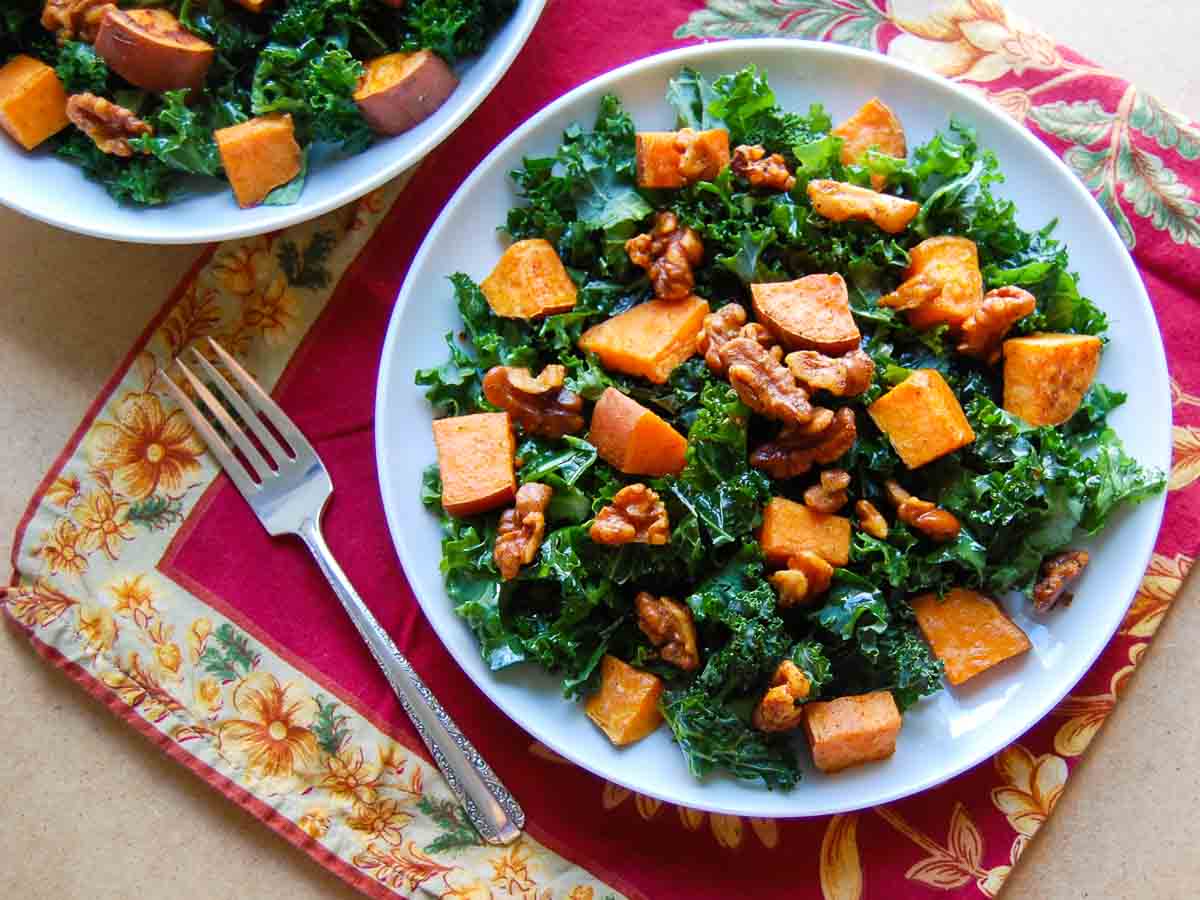 roasted sweet potato and kale salad on a white plate