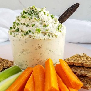 Homemade cashew cream cheese recipe in bowl with crackers.