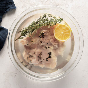 Chicken soaking in a seasoned wet brine.