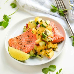 Salmon with pineapple relish on plate