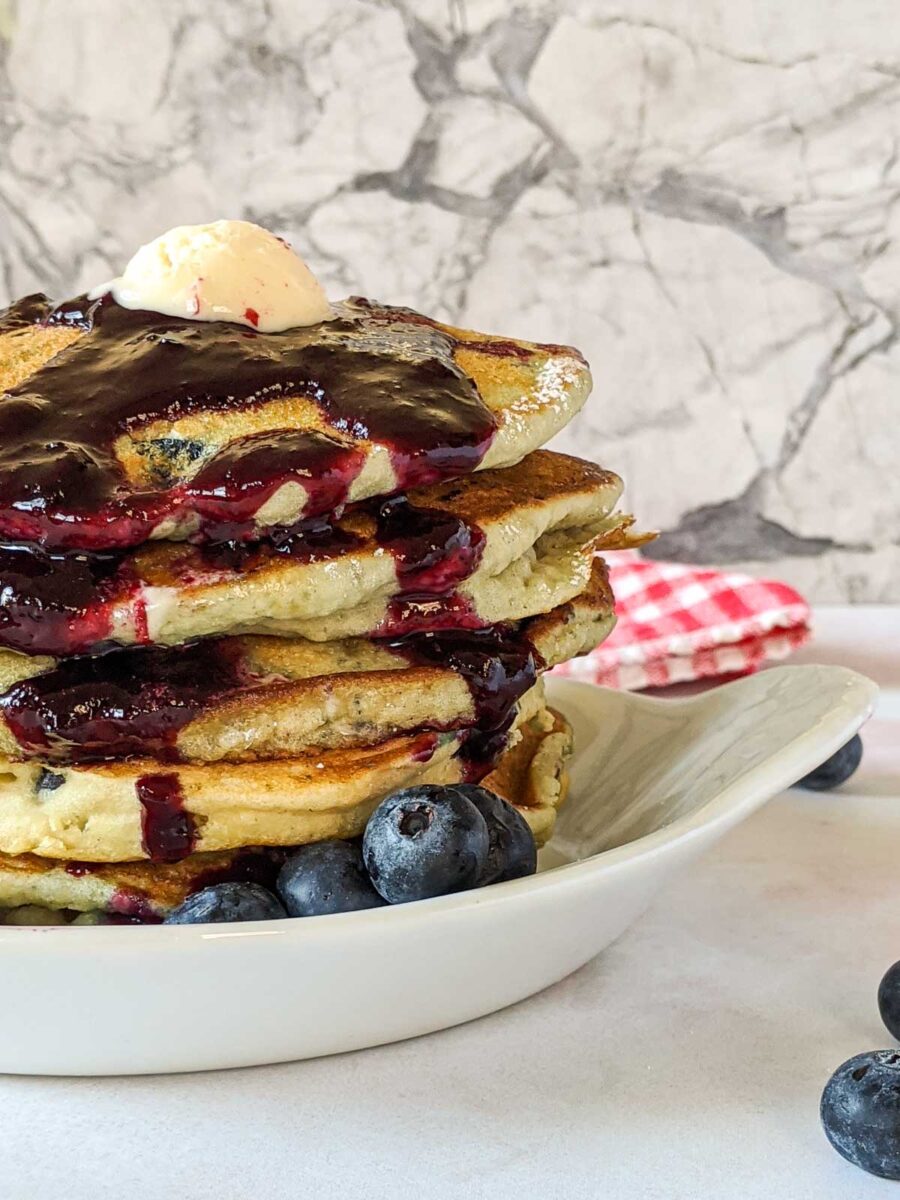 stack of blueberry cakes with blueberry sauce