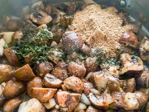adding herbs and porcini powder to pan