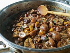 chestnut mushrooms with thyme in pan