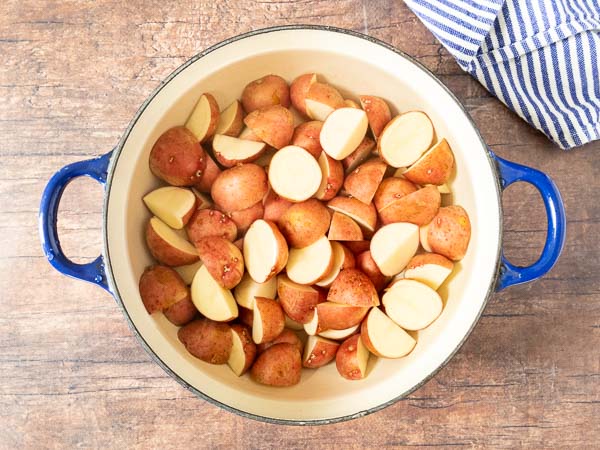 red potatoes in pot and covered with water
