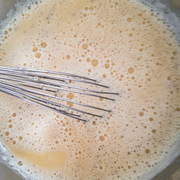 strained eggnog in a bowl