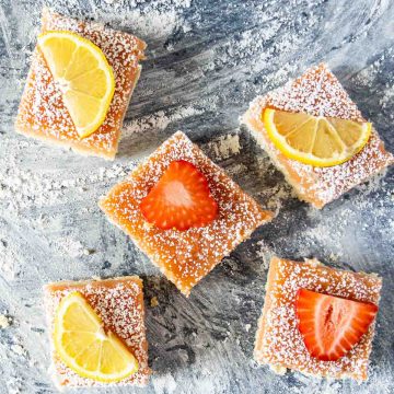 Strawberry lemon bar squares on a counter.