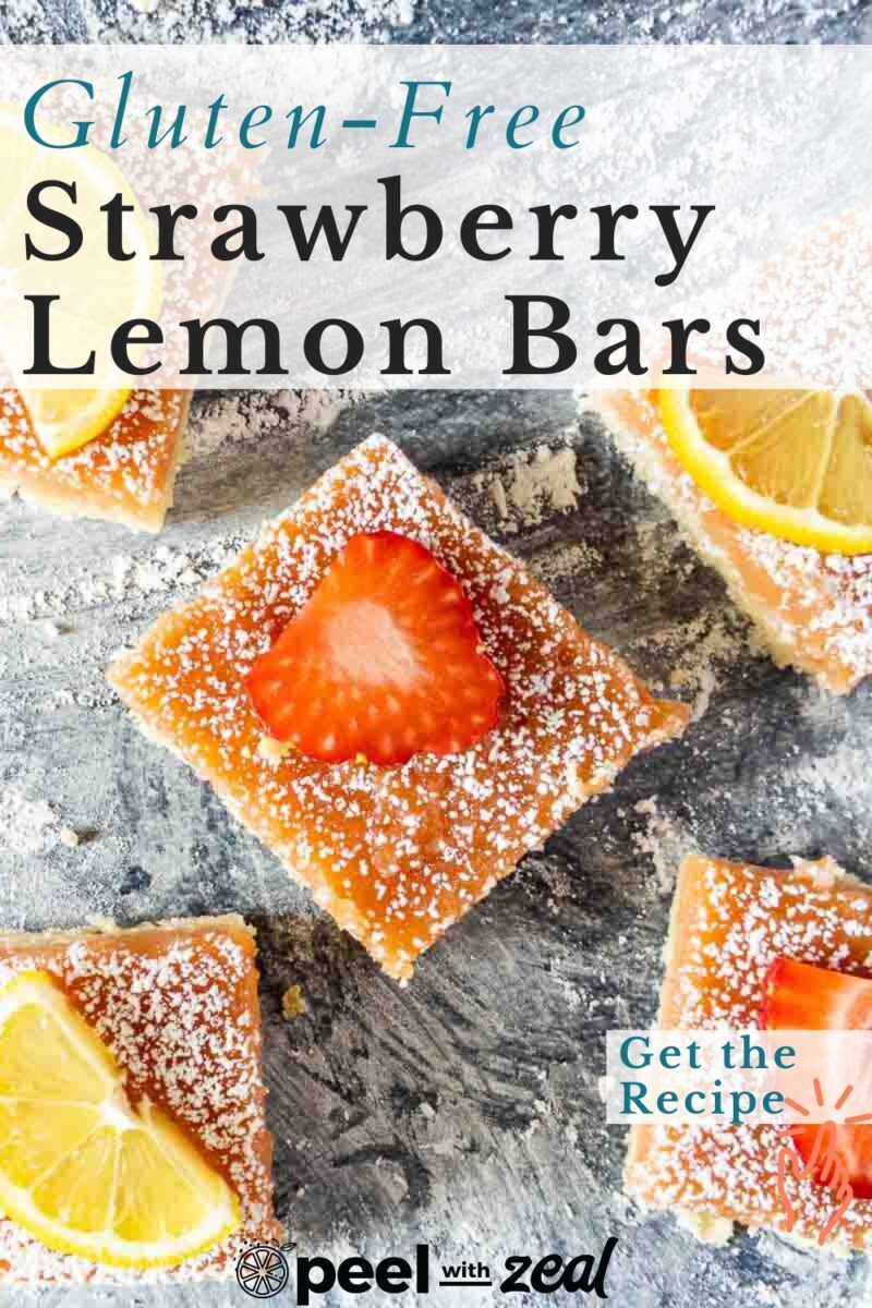 Strawberry lemon bars with fruit slices on top resting on the countertop.