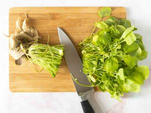 cutting off watercress stems with a knife