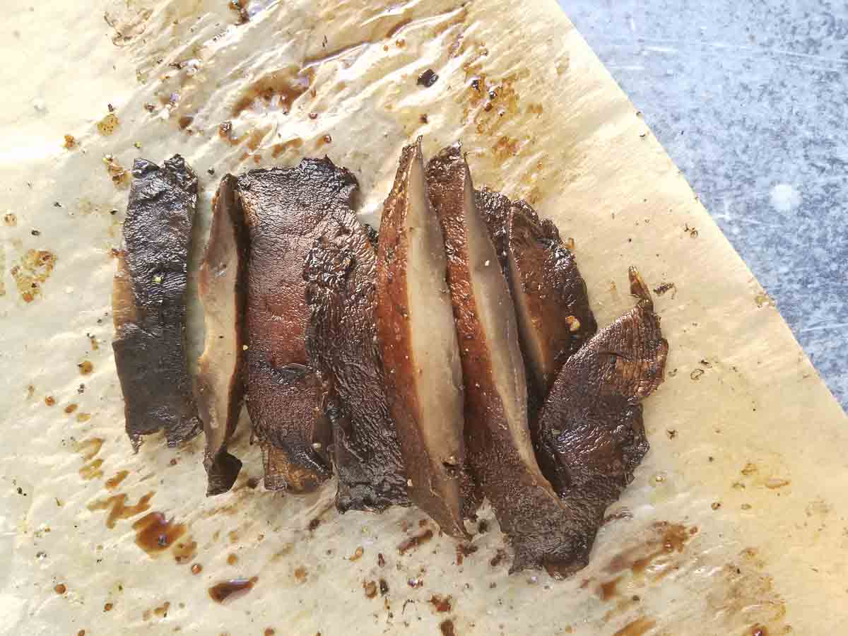 sliced portovbello mushrooms on parchment