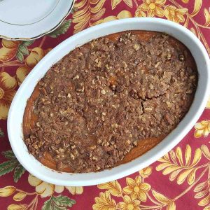 Sweet potato crunch in a white casserole dish.