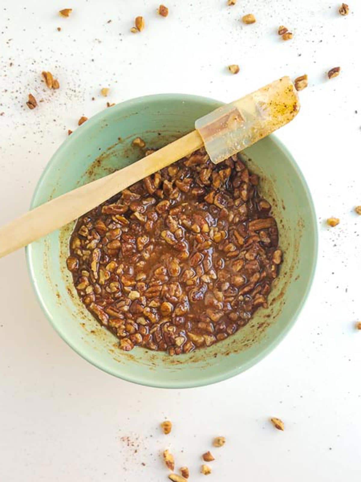 Crunchy pecan and maple topping in a small mixing bowl.