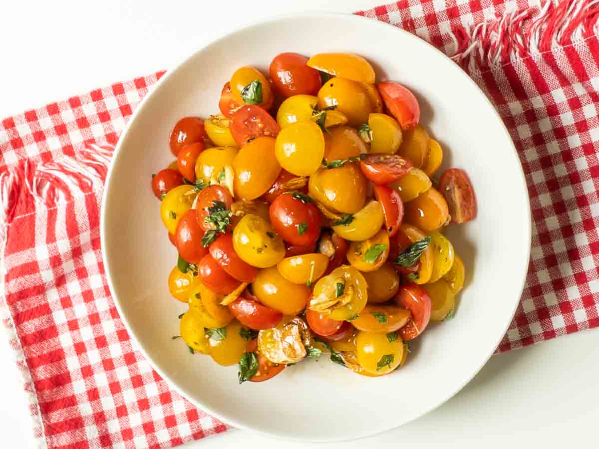 complete cherry tomato salad in mixing bowl