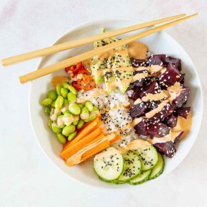 Vegan poke bowl with beets and veggies in a bowl.