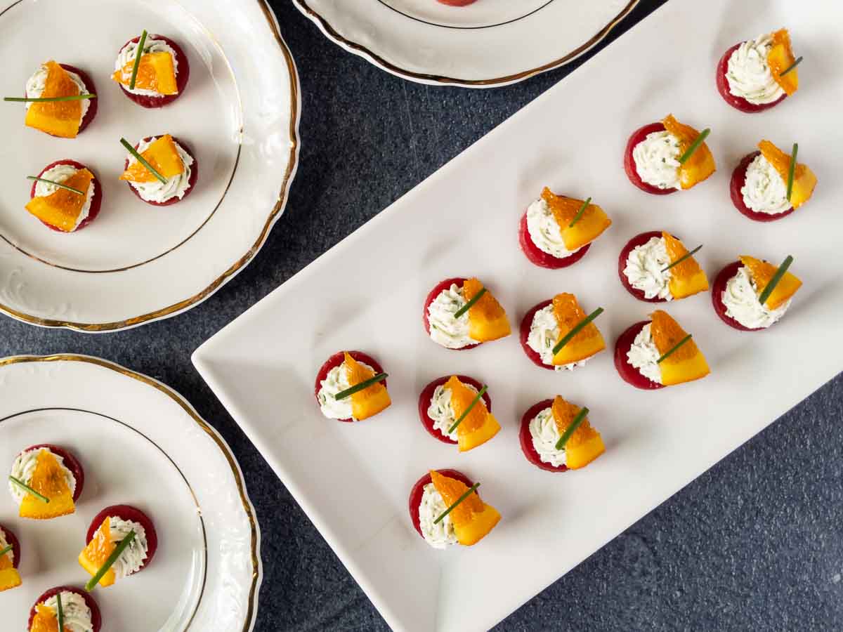 beet bites on platter surrounded by party plates