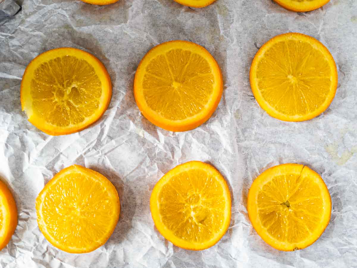 candied oranges cooling on parchment