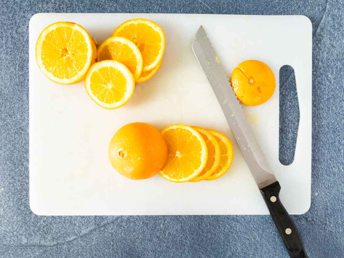 slicing oranges on cutting board