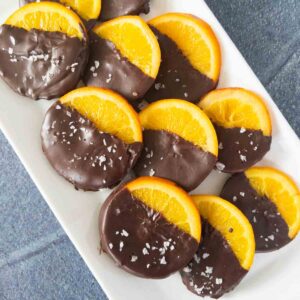 dark chocolate covered oranges on a platter