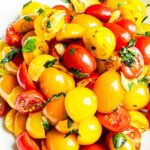 cherry tomatoes with salad dressing in bowl