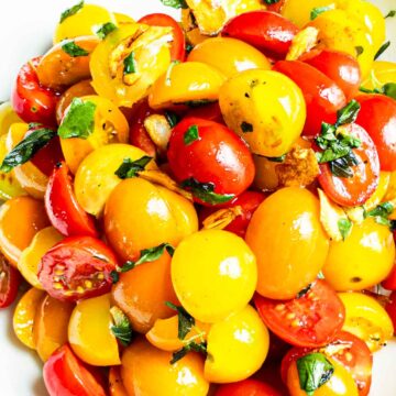 cherry tomatoes with salad dressing in bowl
