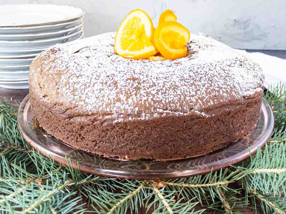 Gluten Free spice cake decorated with oranges and powdered sugar. 