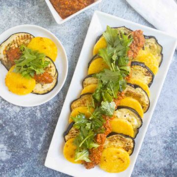 polenta cakes with eggplant and romesco on serving platter