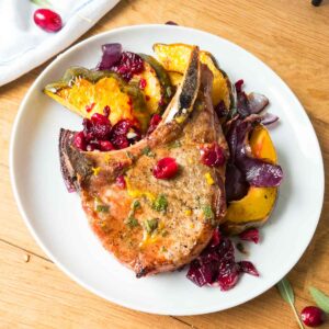 pork chop and acorn squash on dinner plate