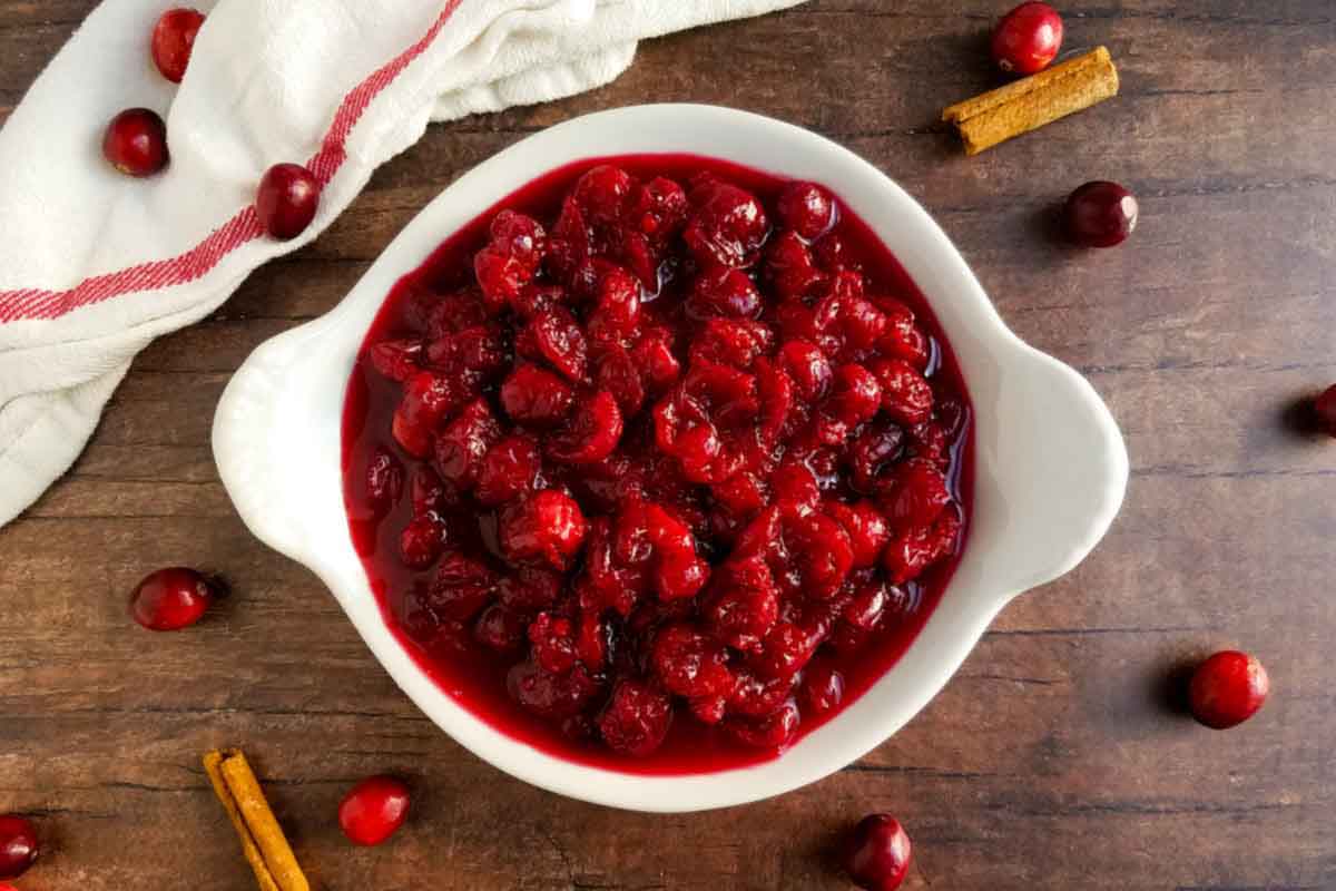 roasted cranberry sauce with towel and cinnamon sticks