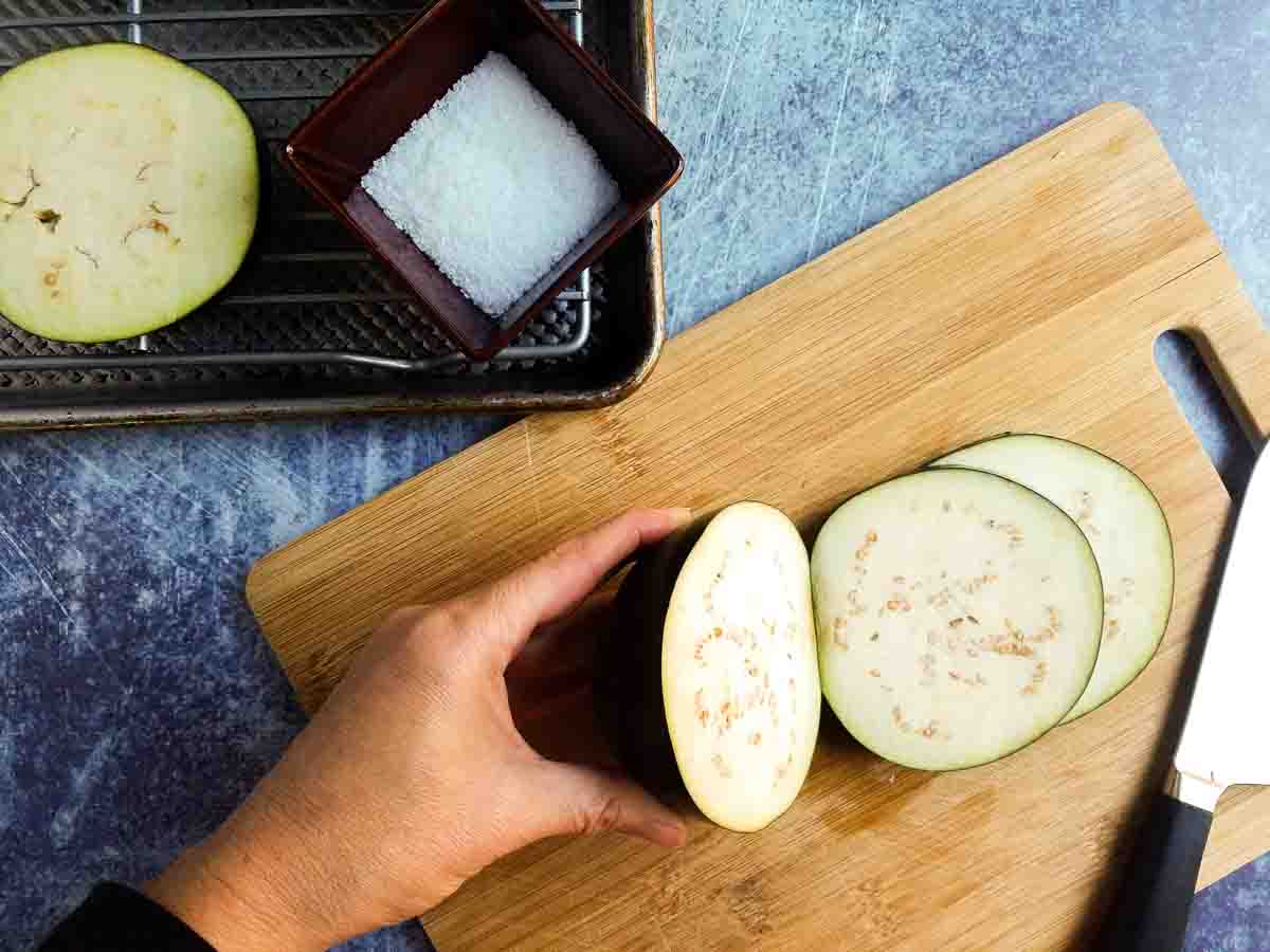 cutting eggplant on a cutting board