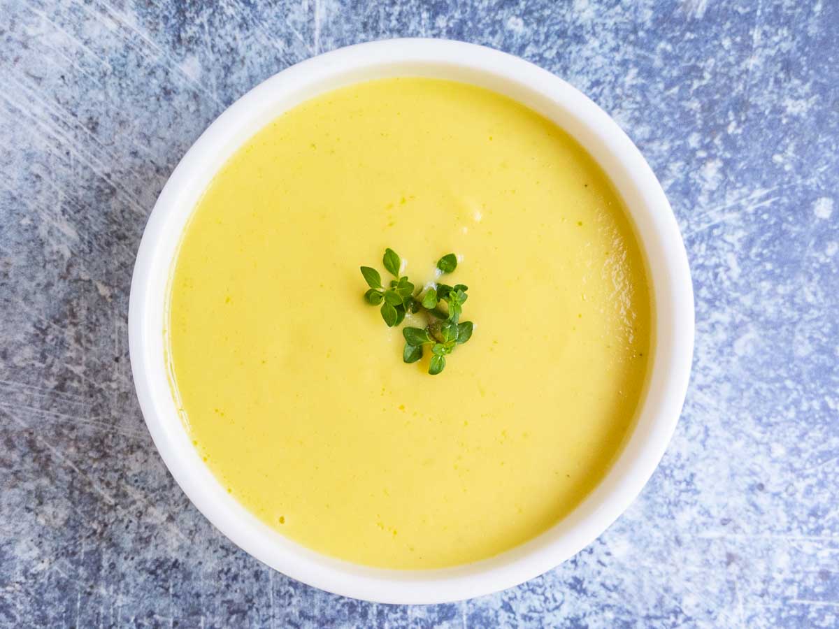 cream of squash soup in white bowl