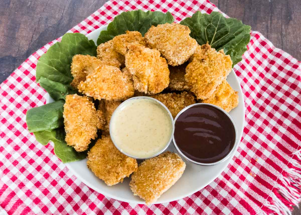 gluten free chicken nuggets on a plate with dipping sauces