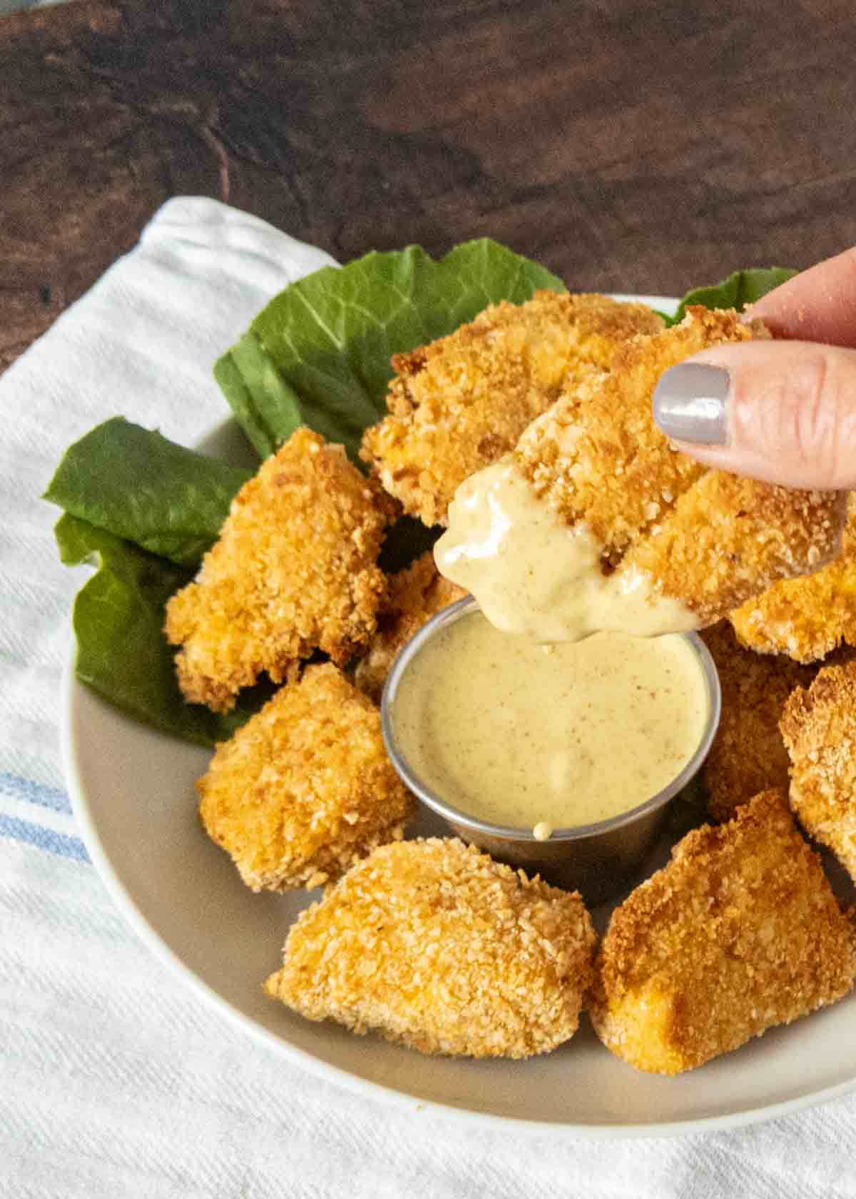 chicken nugget dunked in honey mustard