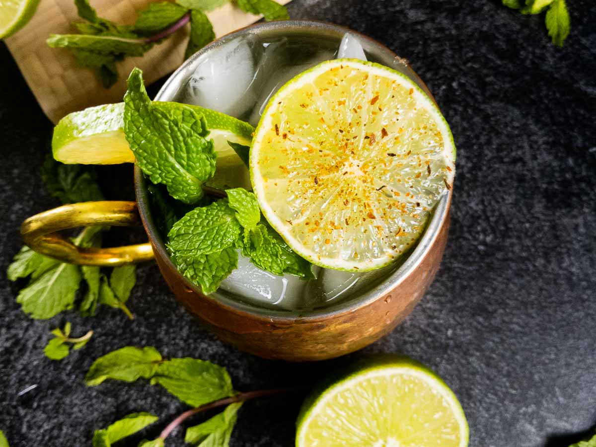 Close up of spicy mezcal mule with cayenne lime wheel