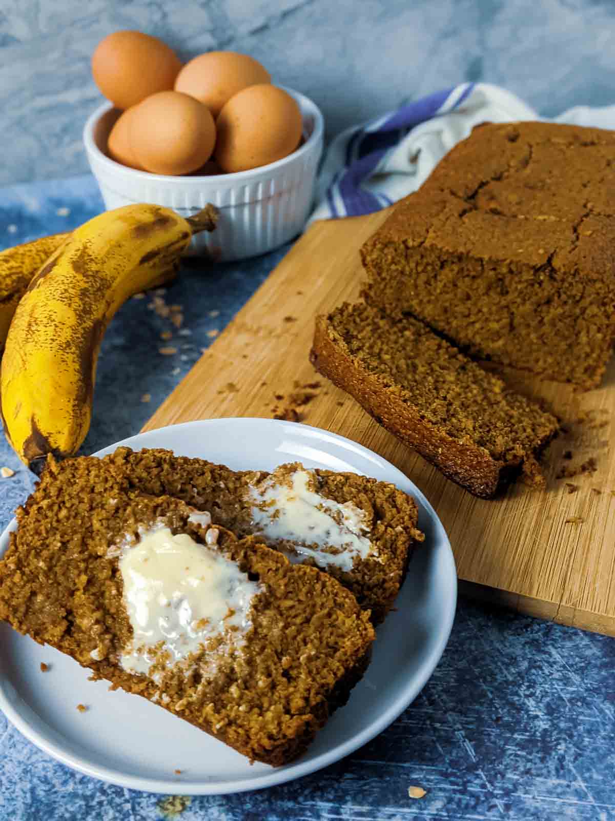 slices of banana bread with butter on white plate