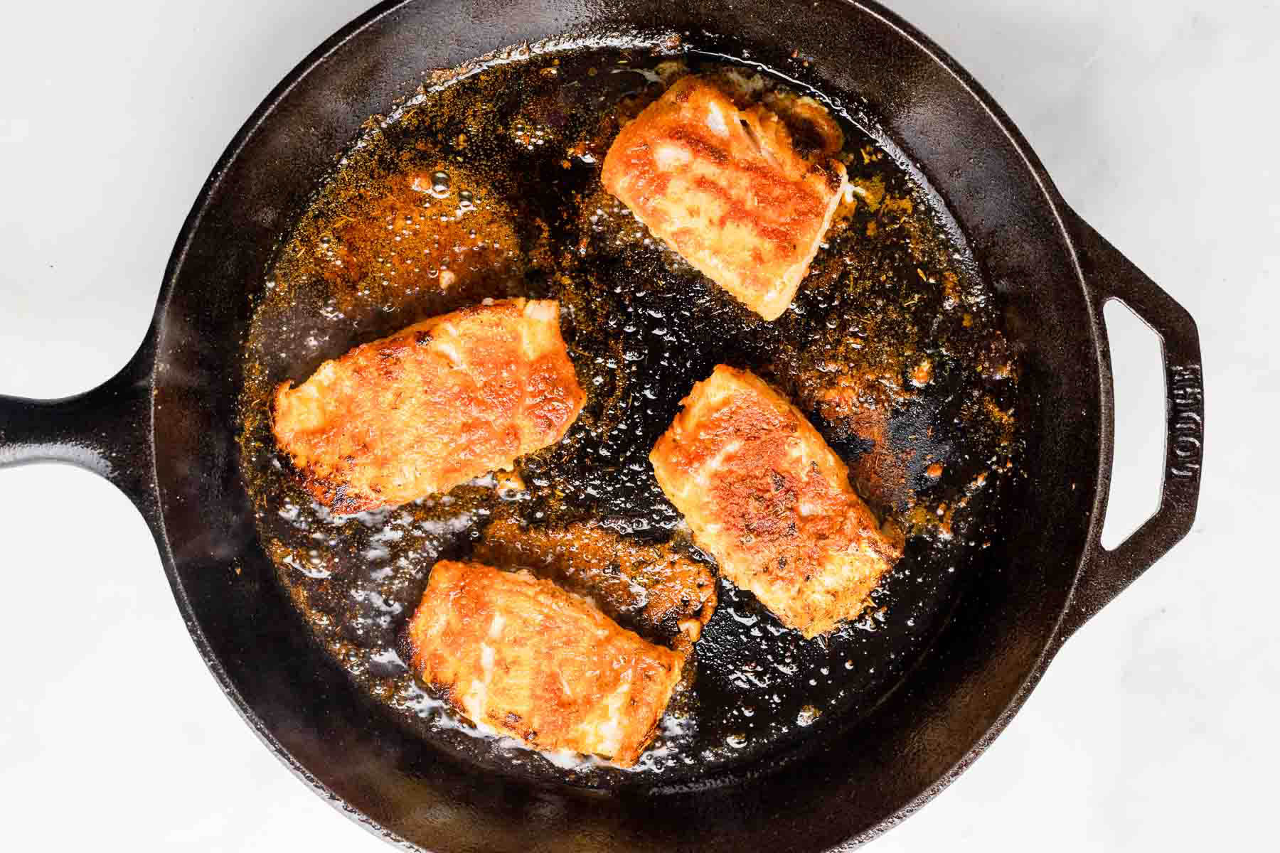 cod cooking in skillet