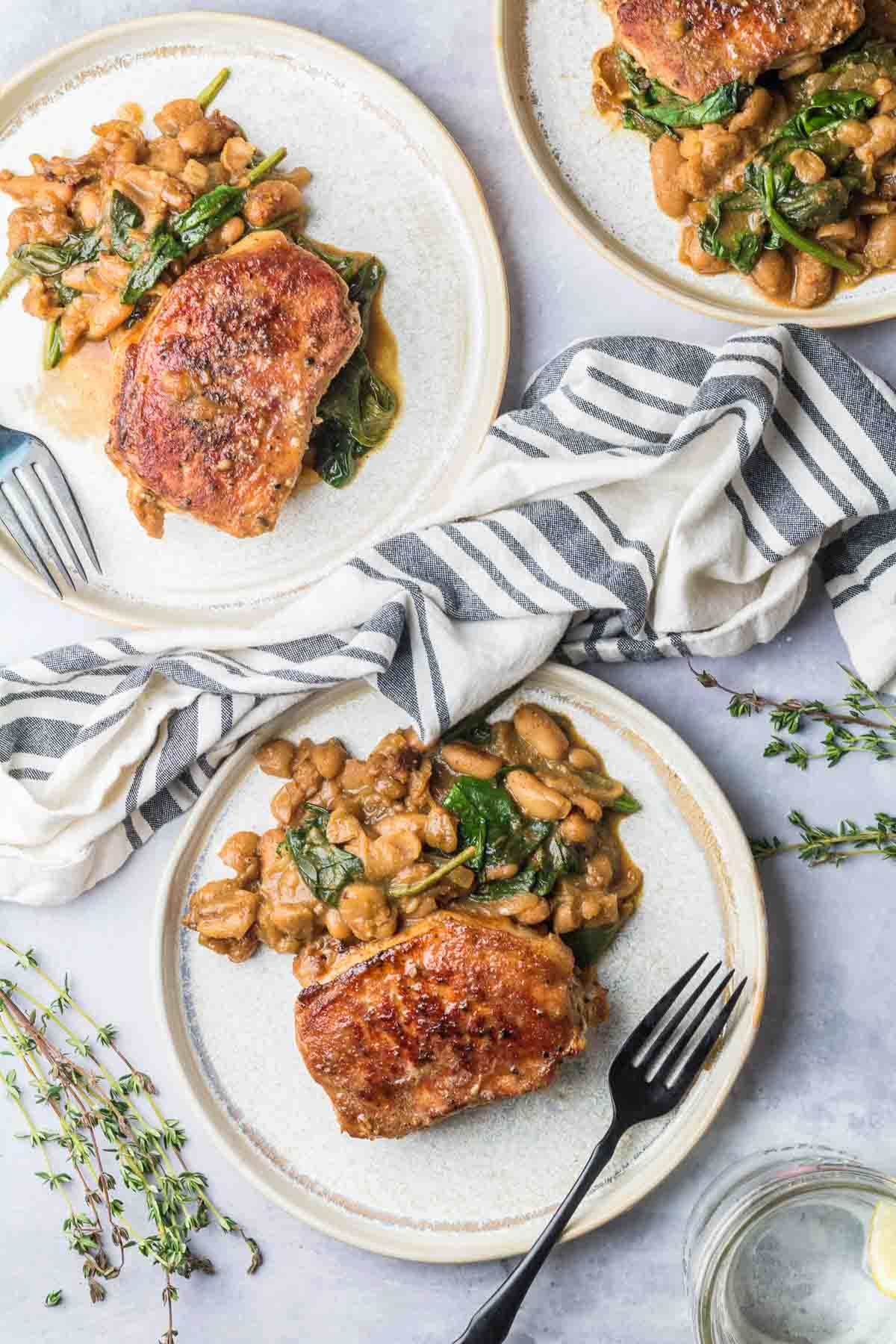 boneless pork chop with white beans on plates