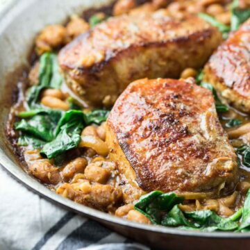 pork chops with spinach in a pan