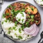 Lamb vindaloo served over rice.
