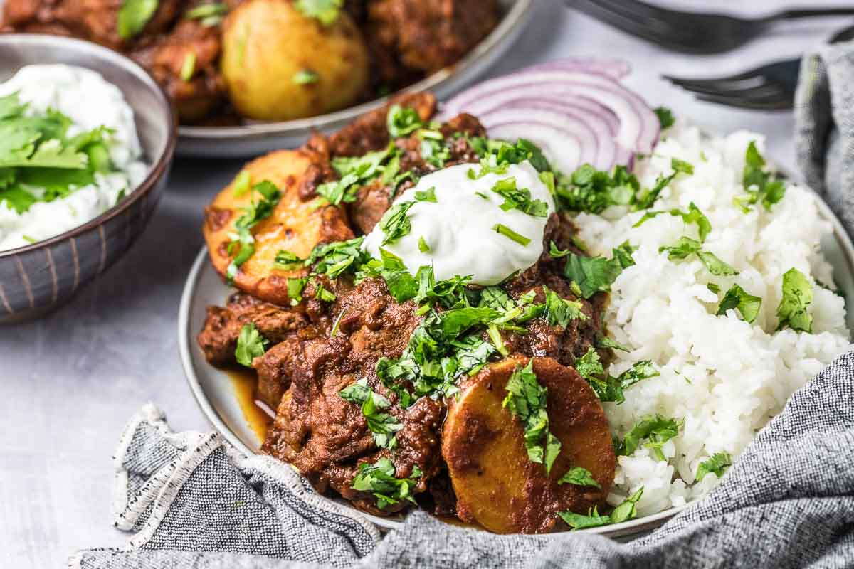 serving suggestion for lamb vindaloo, over rice with onions