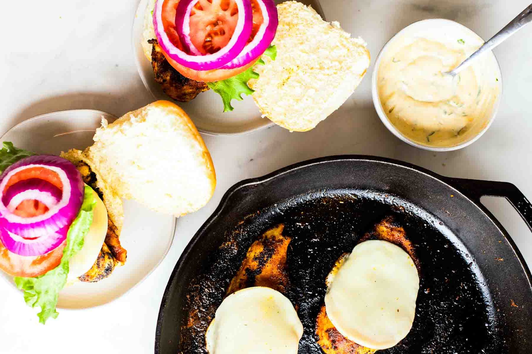 assembling blackened chicken sandwiches.