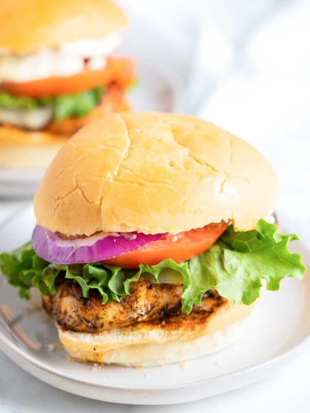 two chicken sandwiches on plates