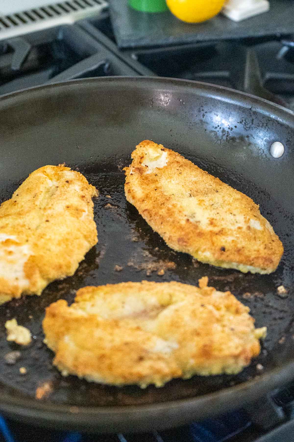 Chicken frying in a pan. 